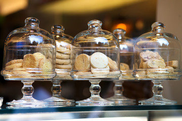 Shortbread Italian style cookies on retail display in glass boxes in store or bakery through window