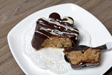 Chocolate dessert in the shape of a flower. Dark chocolate coated. Garnished with white chocolate and sprinkles.