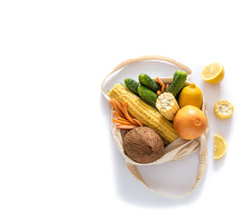 Grocery shopping with eco bag over white background. Zero waste and plastic free concept. Flat lay. Copy space.