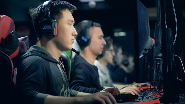 Computer club with a group of men playing a MMORPG