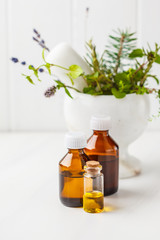 Bottles of essential oil, white background. Healthy cosmetics concept.