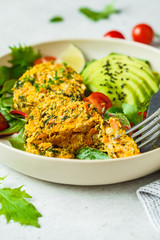 Vegan pumpkin and quinoa cutlets with salad in a white plate.