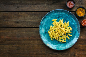 pasta, penne, basil and sauce (set of ingredients). top food background. copy space