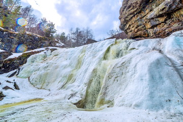 Beautiful frozen gadelsha waterfall in the southern Urals in the Republic of Bashkortostan on a...