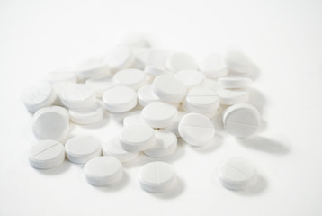 Fototapeta na wymiar white pills on a white background