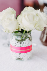 Wedding Table Decor Detail Flower Bouquet Closeup. Delicate Floristics, Bunch of White Roses in Glass Jar Shallow Focus. Arrangement Elegant Serving. Marriage Ceremony Celebration, Luxury Banquet