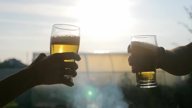 Glass of beer on the sunset. Cooling summer drink concept.