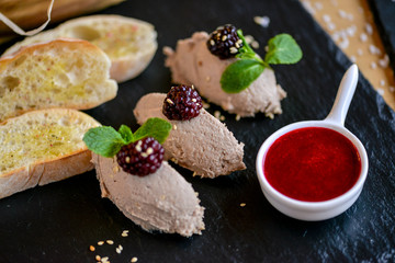 pate on black slate with jam and baguette
