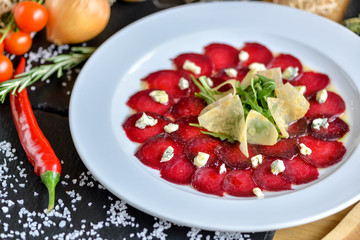 beetroot carpaccio on a white plate