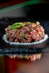 calf tartare on black slate