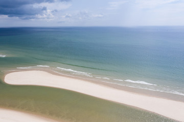 The cold waters of the Atlantic Ocean bathe a scenic beach on Cape Cod, Massachusetts. This beautiful area of New England, not too far from Boston, is a popular summer vacation destination.