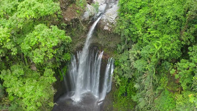 Aerial: Fresh Water Plummeting Onto Rocks From the Tiu Kelap Waterfall in the Tropical Jungle in Bali - Lombok, Bali