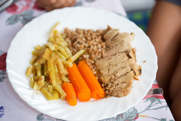 Roasted pork shoulder with buckwheat, cooked beans and carrots 