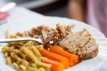 Roasted pork shoulder with buckwheat, cooked beans and carrots 