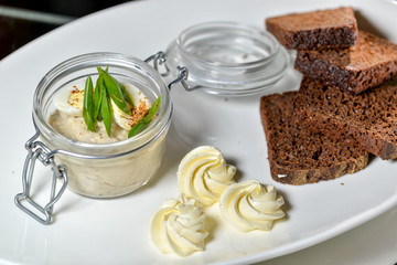 pate with bread on a square plate in a beautifully served