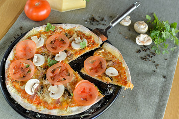 Fototapeta na wymiar pizza with tomatoes and mushrooms