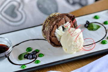 chocolate fondant dessert with ice cream on a white rectangular plate in a restaurant on the table