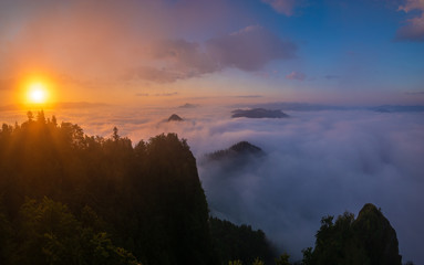 beautiful, spectacular sunrise above the clouds at the top of Three Crowns-Pieniny, Poland