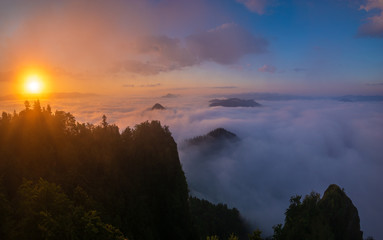 Naklejka premium beautiful, spectacular sunrise above the clouds at the top of Three Crowns-Pieniny, Poland