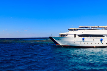 White yacht anchored near coral reef in Red sea, Egypt