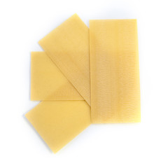 Raw pasta lasagne isolated over white background.