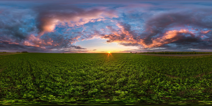 full seamless spherical hdri panorama 360 degrees angle view among fields in summer evening sunset with awesome blue pink red clouds in equirectangular projection, ready for VR AR virtual reality