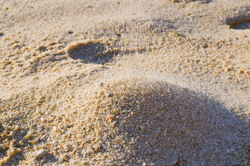 Fototapeta na wymiar Sand falling on a beach