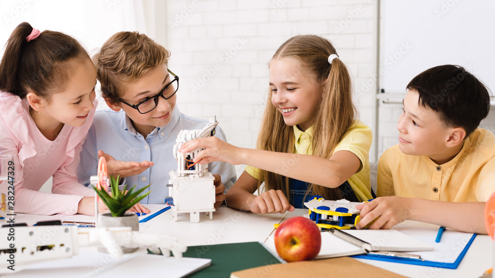 Poster Happy children constructing robotic device at stem class