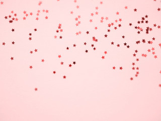 Fototapeta na wymiar Golden stars glitter on pink background
