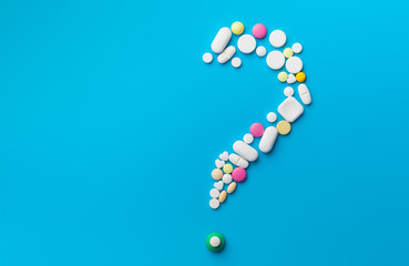 Medicine pills, tablets and capsules over blue background
