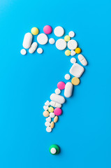 Medicine pills, tablets and capsules over blue background