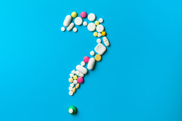 Medicine pills, tablets and capsules over blue background