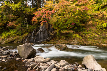 Autumn leaves and waterfall at Nakano Momiji mountain, Kuroishi, Aomori, Japan