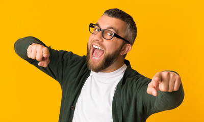 Fototapeta premium Cheerful bearded man happily indicating at camera