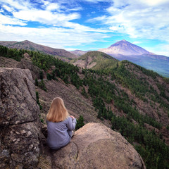 Girl enjoying the view of  volcano Teide in Teide National Park of Tenerife.