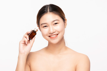 Beautiful Asian young woman smile and holding serum for Moisturize skin smile with healthy Clean and Fresh skin feeling so happiness and cheerful,Isolated on white background,Beauty Concept