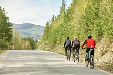 group of cyclists on a forest road