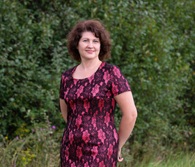 Woman in a red dress on summer nature