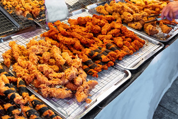 Deep fried shrimps and crispy chicken skin, Thai street food at flea market