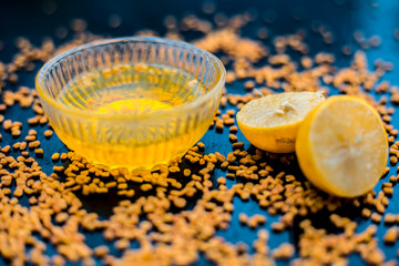 Famous natural method for dandruff on wooden surface in a glass bowl consisting of fenugreek seeds...