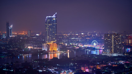 Fototapeta na wymiar night cityscape along chao praya river of bangkok