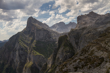 Mountains with vertical walls touching the clouds.