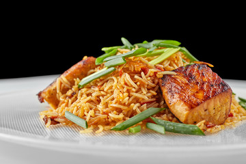 Pilaf with salmon on a white plate