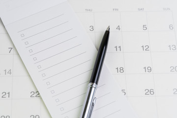 Pen on checklist with checkbox notepad on clean calendar using as special event, planner, important reminder or appointment list concept