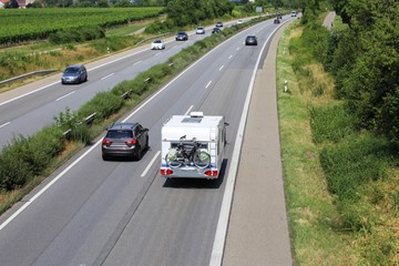 Car towing caravan on european motorway