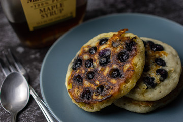Blueberry pancake on a plate on dark background. Selective focus.