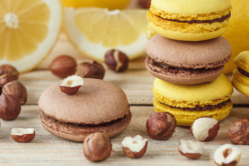 Obraz na płótnie Canvas Yellow and brown french macarons with lemon and hazelnuts