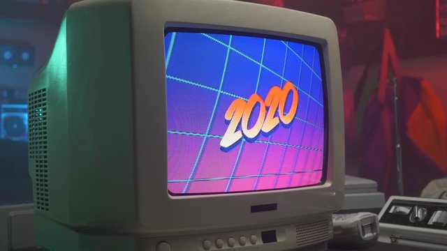 Animation of the year 2020 title appearing on a retro 80s 90s television monitor