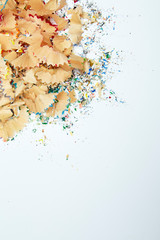 Naklejka premium Shavings from multicolored pencils on white