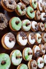 Delicious donuts on wooden stander. Wedding in the forest. Wedding decor. Donuts for guests - 282257934